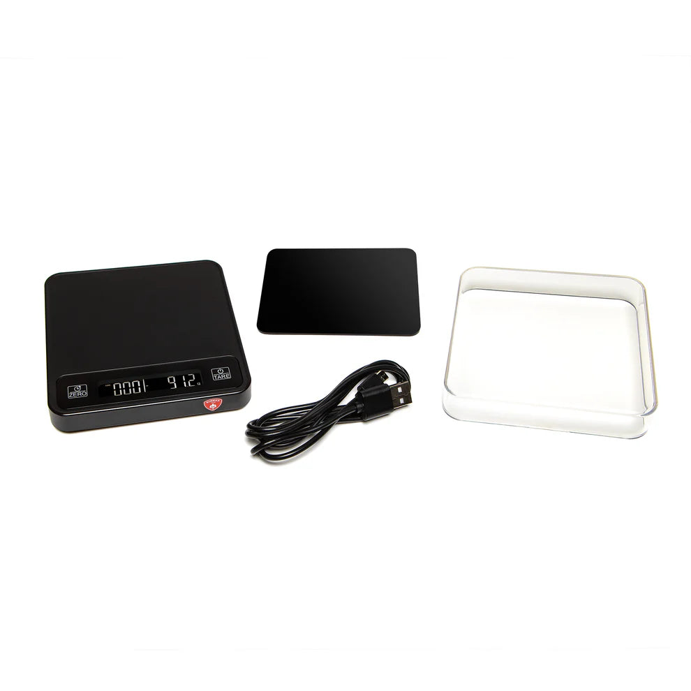 Eureka Precisa scale accessories including USB charging cable, protective cover, and silicone mat.
