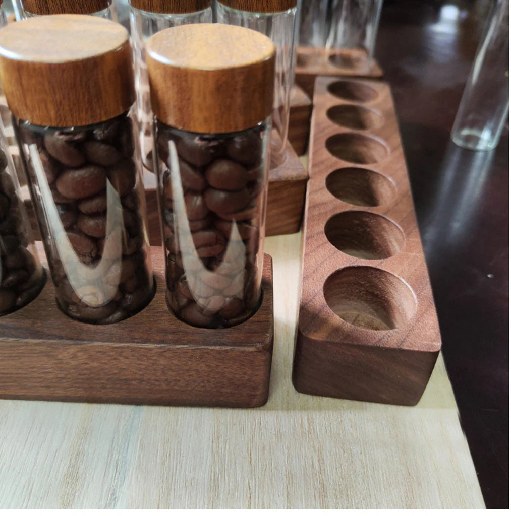 Wooden and glass containers with wooden lids on a wooden stand.