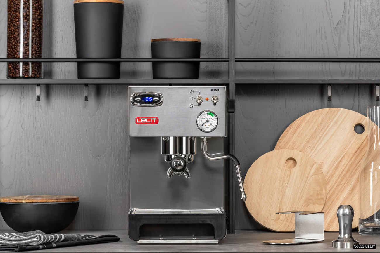Leif coffee machine on a kitchen counter with wooden cutting boards and kitchen tools.