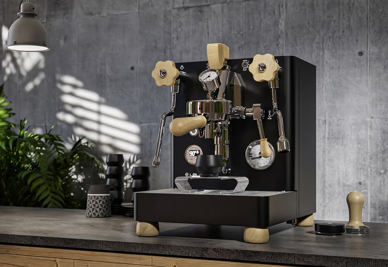Espresso machine on a wooden counter with a gray wall background