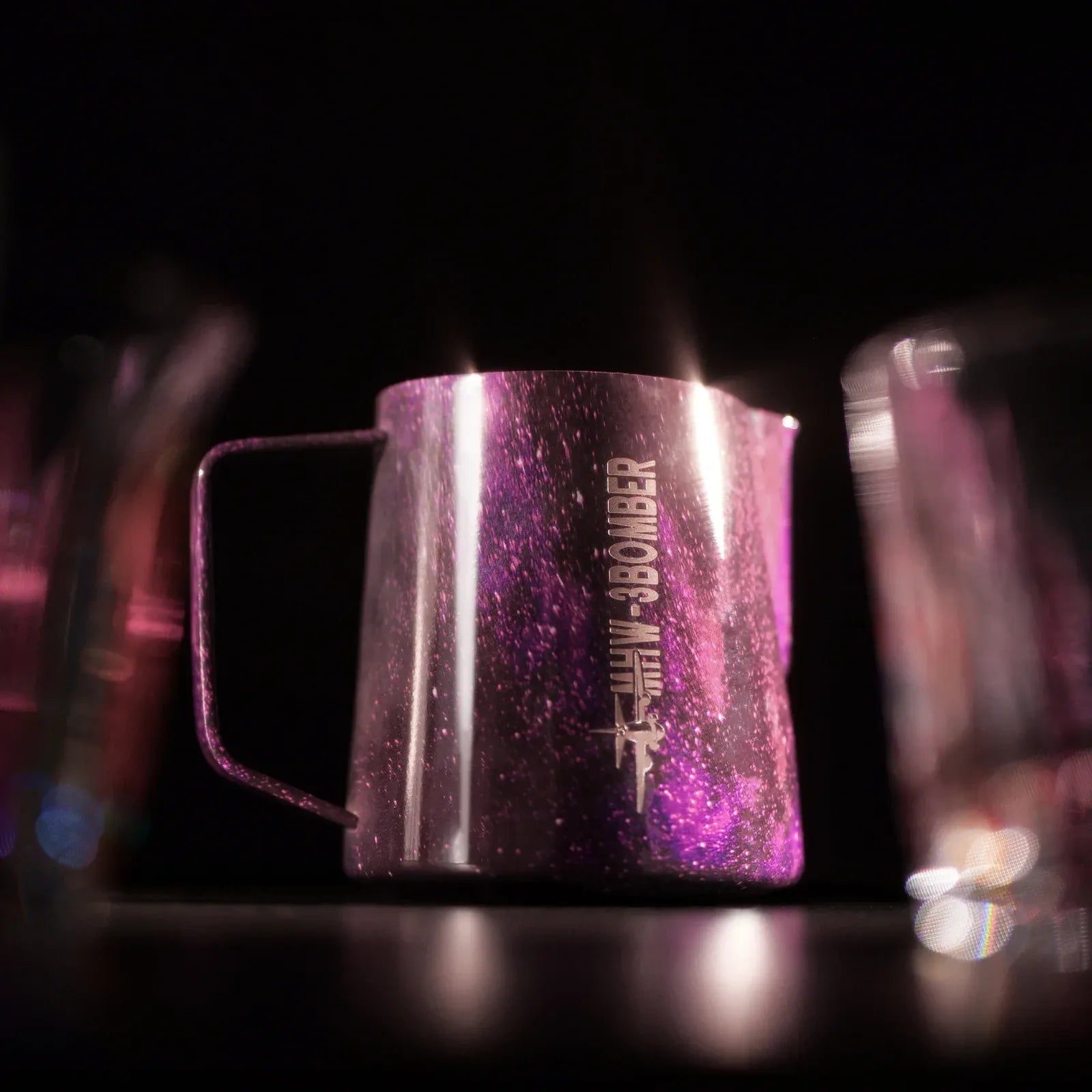 Pink glittery milk pitcher with 'The Bar' branding on a dark background