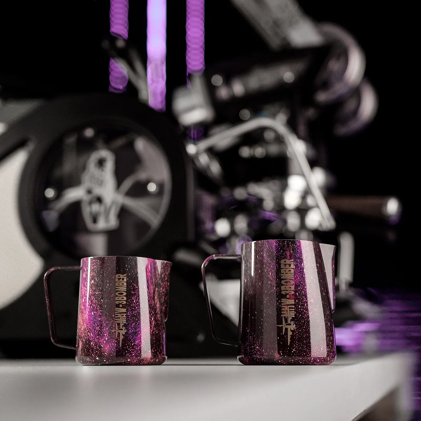 Two purple glitter mugs with a blurred motorcycle in the background