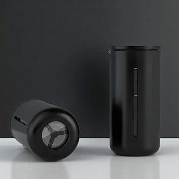 Two black cylindrical products on a white surface with a dark background