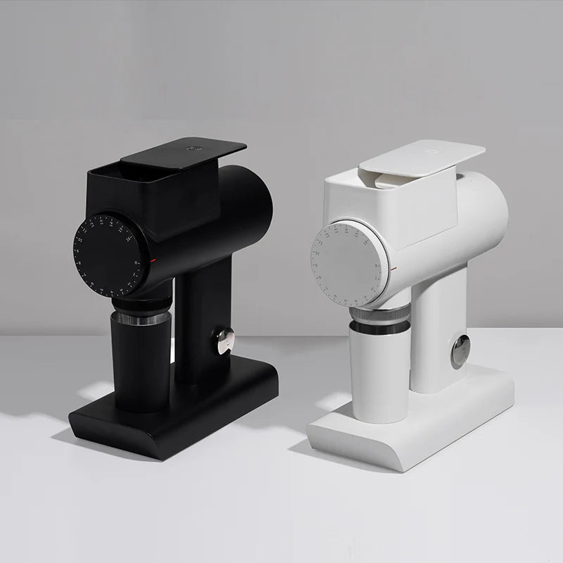 Black and white manual coffee grinders on a light gray background