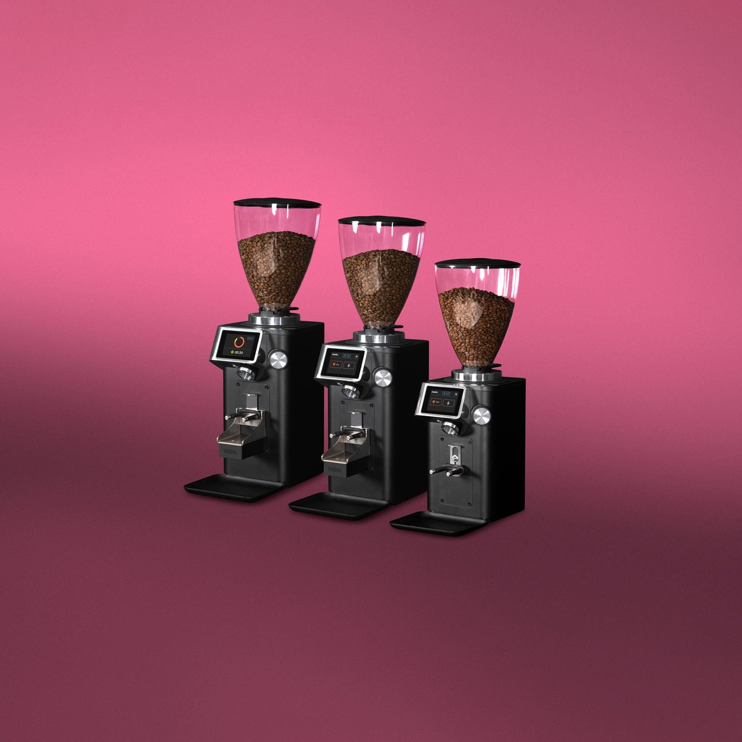 Three Ceado REV Zero grinders arranged together with pink background showcasing different sizes