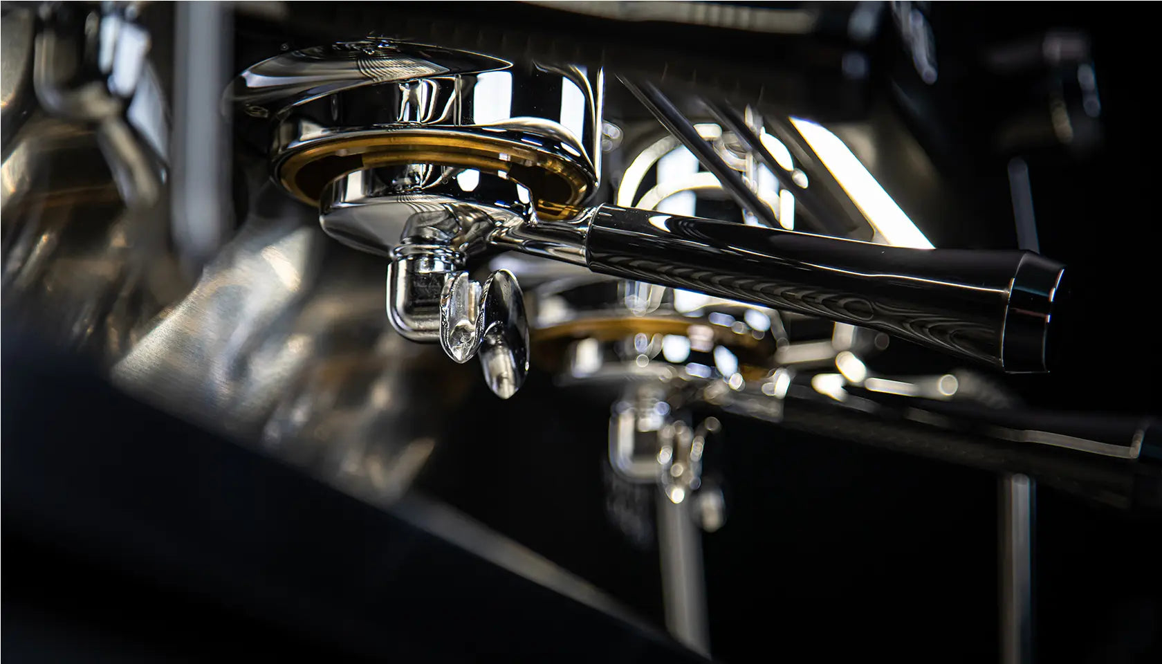 Close-up detail of Dalla Corte Icon dual group heads with professional portafilters and LED lighting

