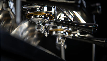 Close-up detail of Dalla Corte Icon dual group heads with professional portafilters and LED lighting
