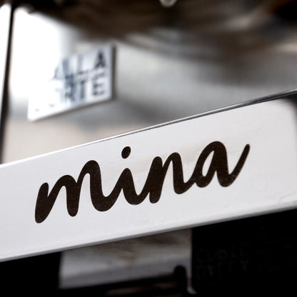 Professional barista operating Dalla Corte Mina with flow profiling controls
