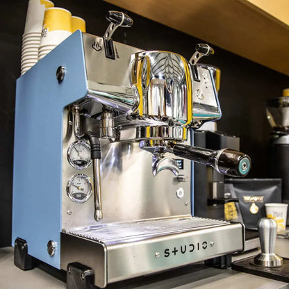 Professional barista operating Dalla Corte Studio Aqua with steam wand and digital controls
