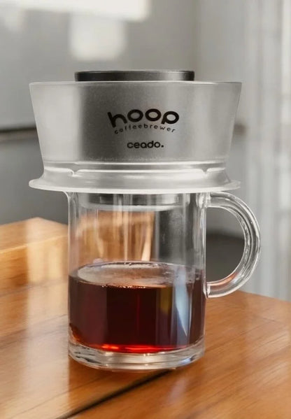 Hoop Coffee Brewer in use brewing coffee into a glass carafe
