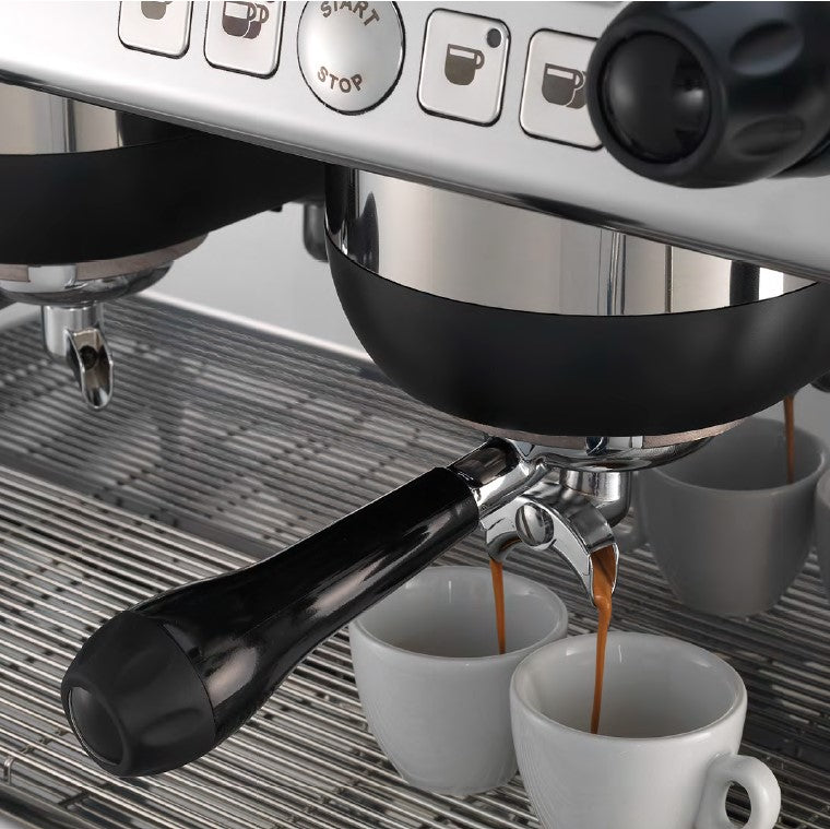 Close-up of espresso extraction from Nettuno A/2 group head into professional cup

